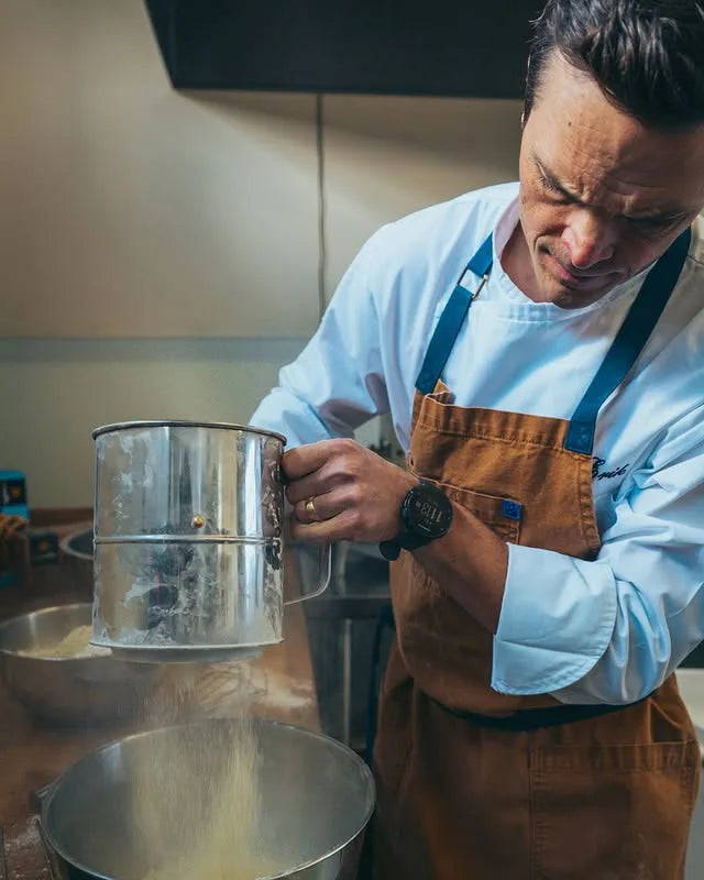 Founder Erik sifting flour in the Unwaffle kitchen